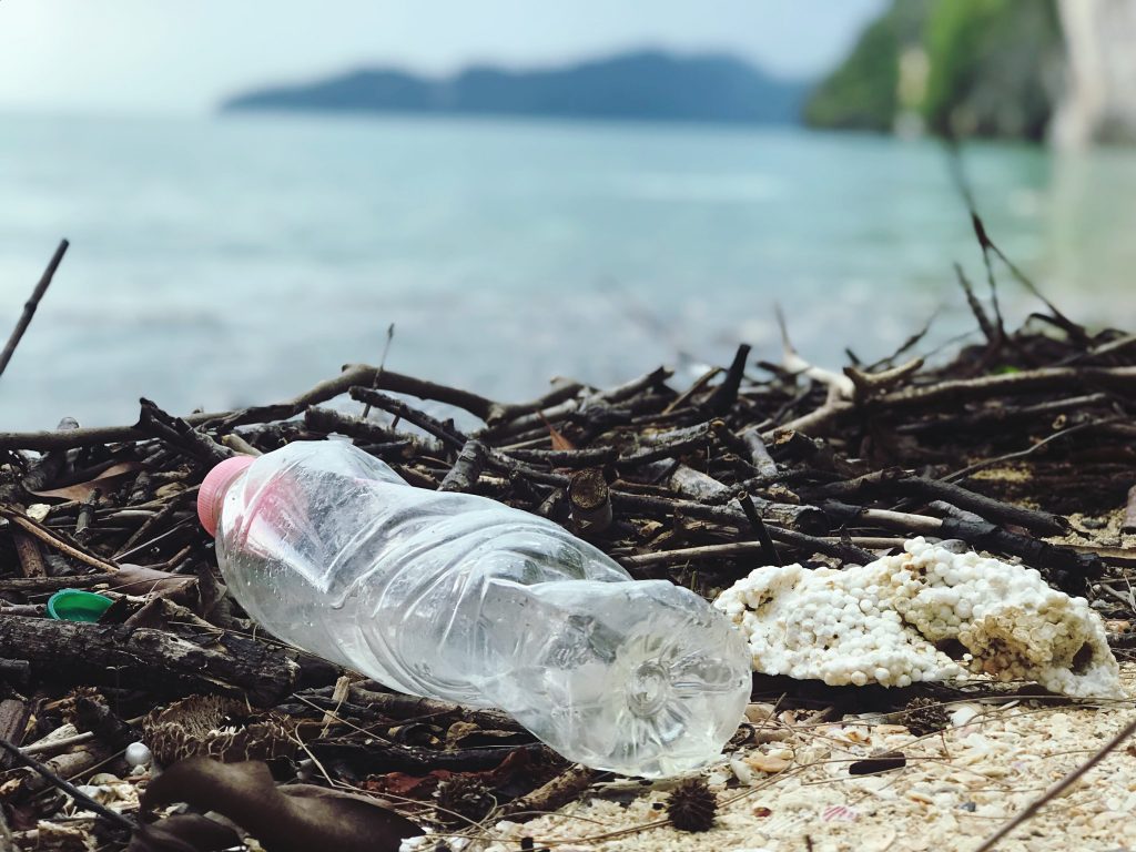 plastic bottle and polystyrene washed up on beach